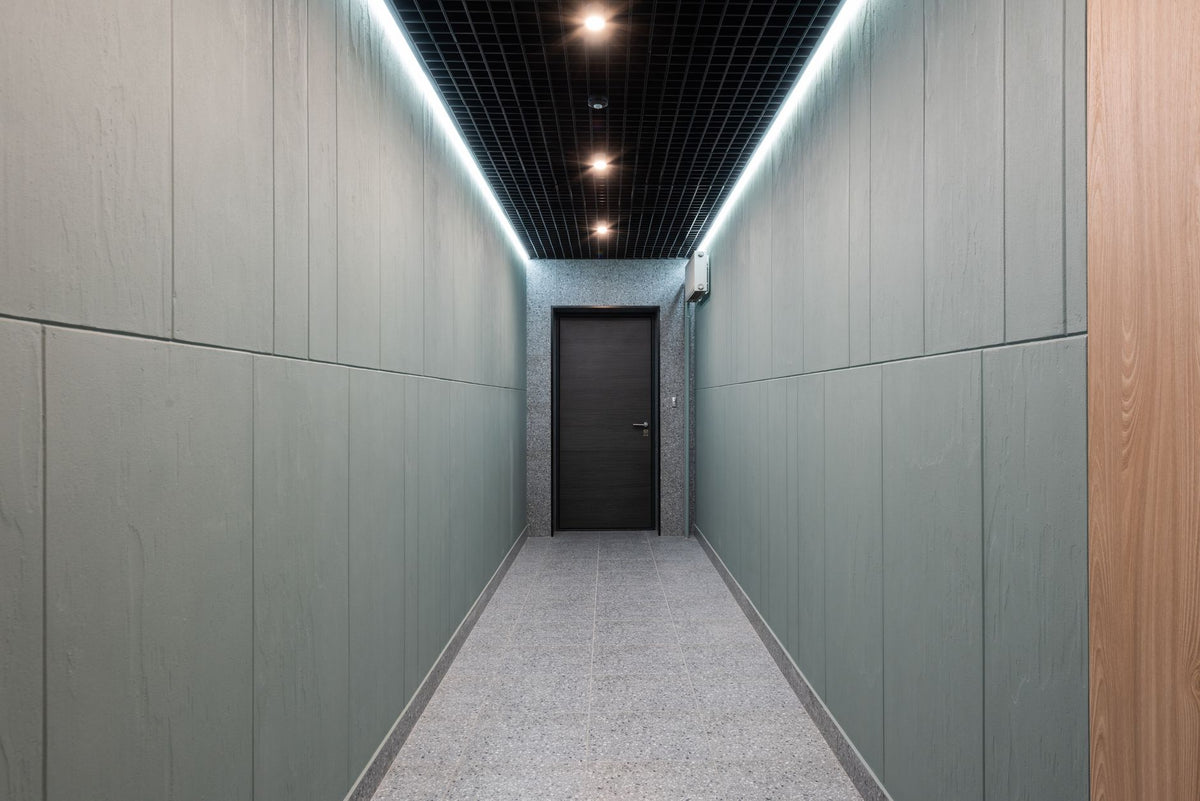 Perspective view of empty hallway with entrance door and illuminated ceiling in contemporary workplace