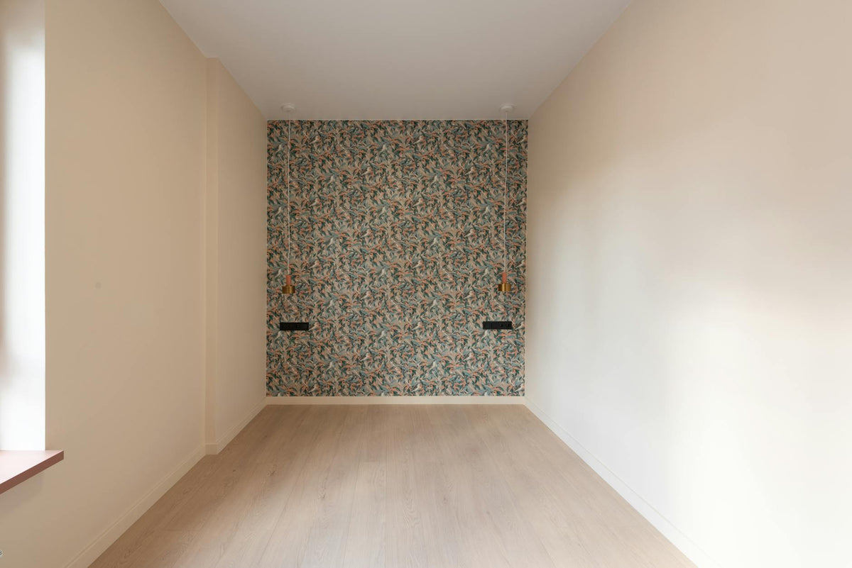 Interior of empty spacious room with parquet floor and colorful wall with sconces in new flat