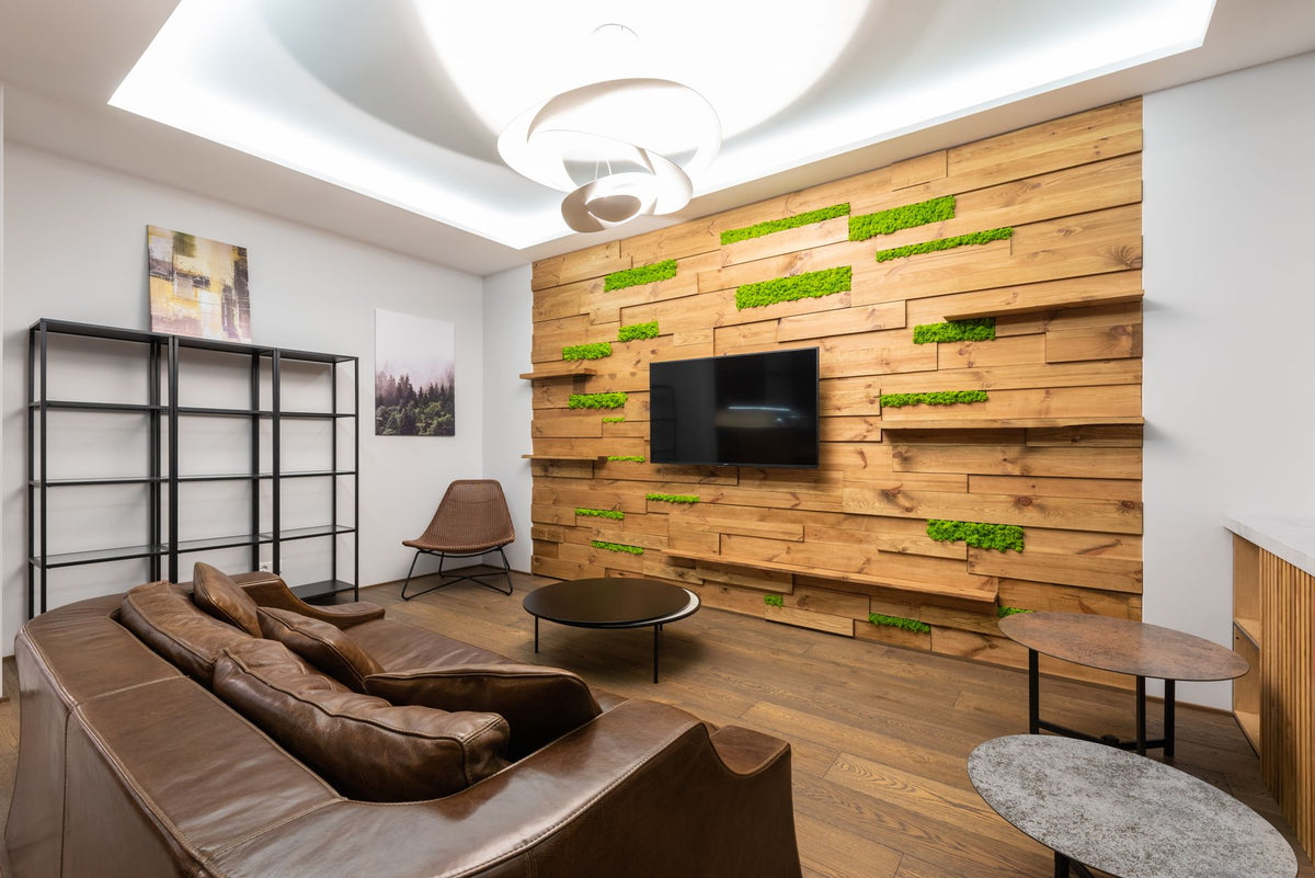 Stylish modern living room with wood accent wall and leather couch.