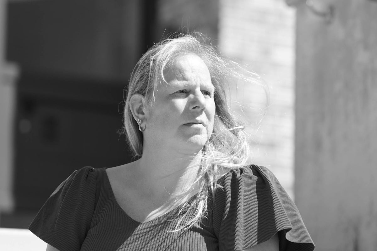 Candid black and white portrait of a person outdoors, highlighting mood and expression.