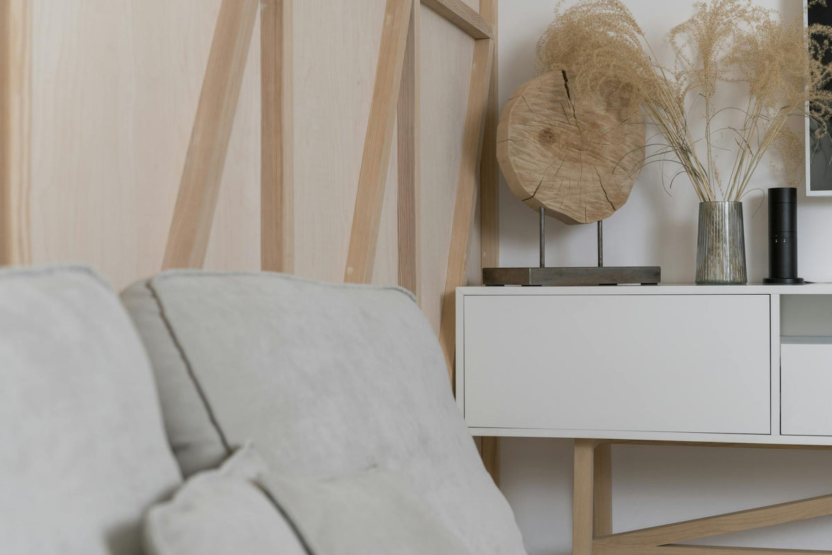 Elegant minimalist interior featuring pampas grass and modern decor elements on a sleek sideboard.